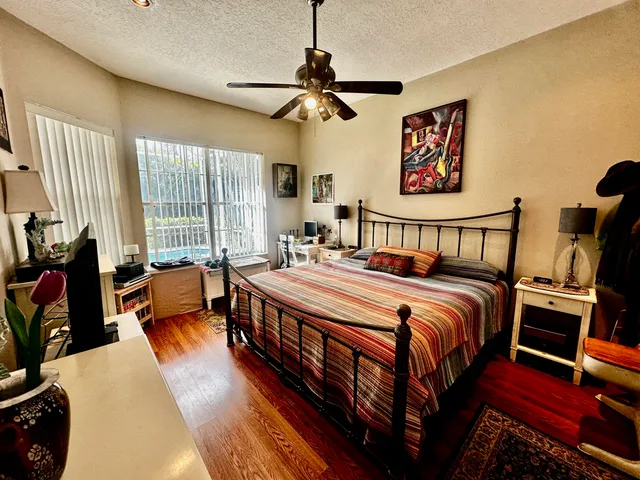 a bedroom with furniture and a flat screen tv