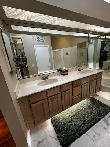 a bathroom with a double vanity sink and mirror