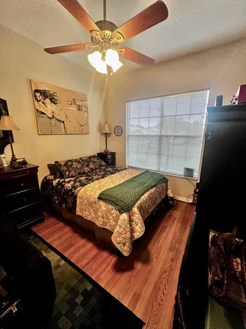 a bedroom with a bed window and wall painting