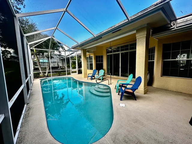 a view of a swimming pool with a lounge chairs