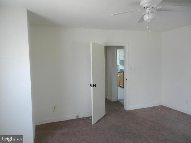 5715 Simmonds Avenue Baltimore, MD 21215 - Photo 12 of 12 an empty room with a ceiling fan and entryway