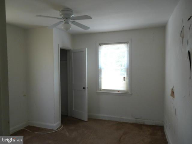 5715 Simmonds Avenue Baltimore, MD 21215 - Photo 6 of 12 an empty room with a window and a fan