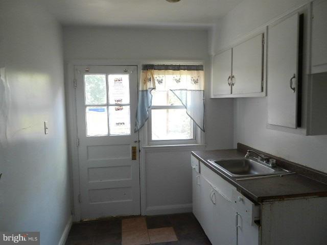 5715 Simmonds Avenue Baltimore, MD 21215 - Photo 7 of 12 a kitchen that has a sink and a window