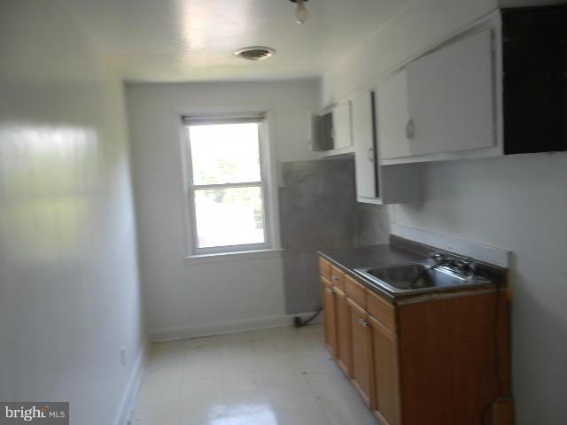 5715 Simmonds Avenue Baltimore, MD 21215 - Photo 9 of 12 a kitchen that has a sink and a stove