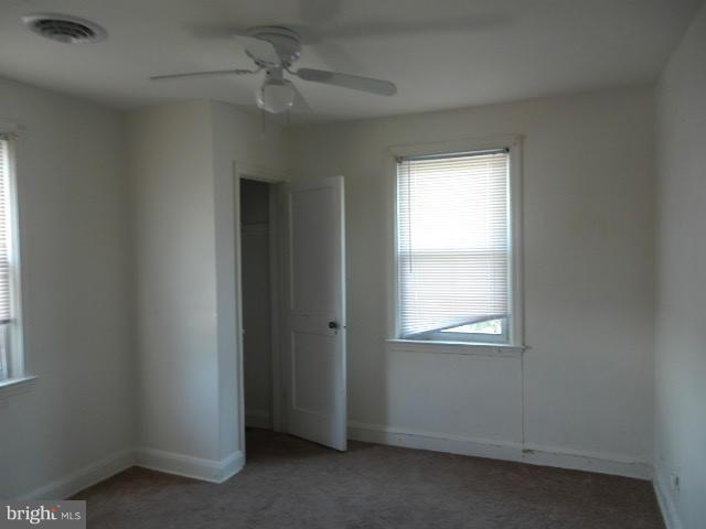 5715 Simmonds Avenue Baltimore, MD 21215 - Photo 10 of 12 an empty room with a window and a fan