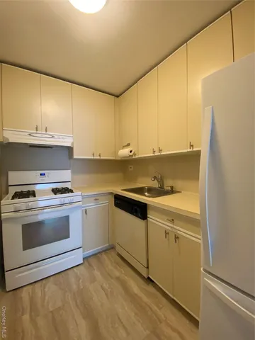 a kitchen with a sink cabinets and stainless steel appliances
