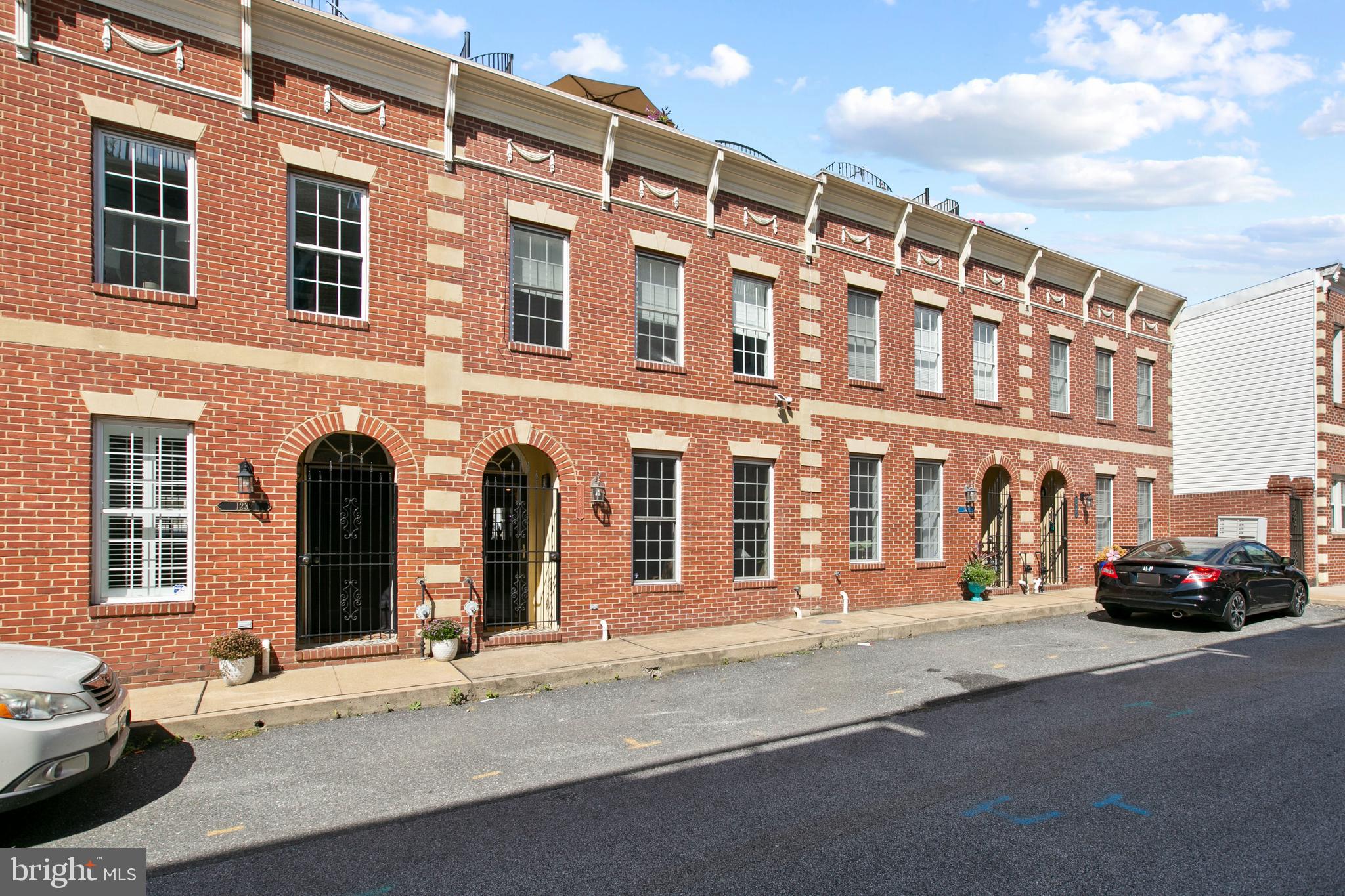 1230 Cooksie Street Baltimore, MD 21230 - Photo 1 of 41 a front view of a building with car parked