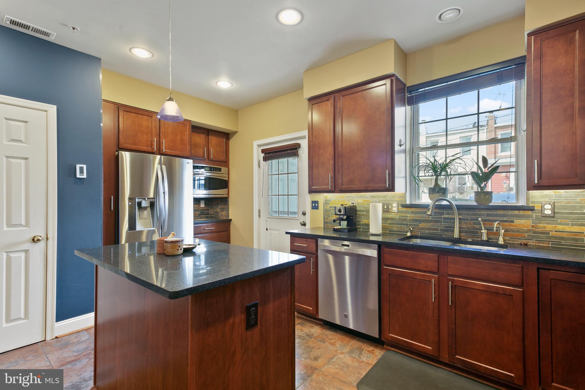 1230 Cooksie Street Baltimore, MD 21230 - Photo 13 of 41 a kitchen with stainless steel appliances granite countertop a sink refrigerator and cabinets