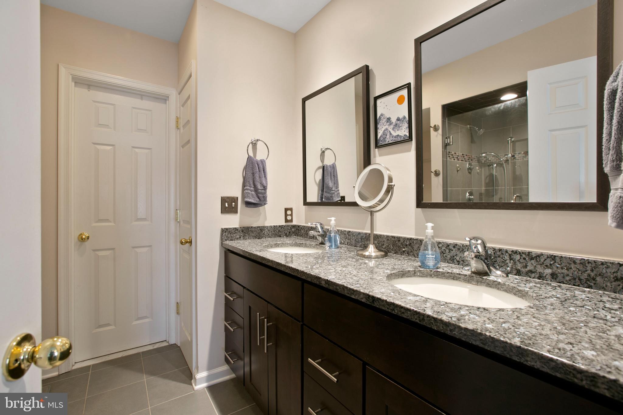 1230 Cooksie Street Baltimore, MD 21230 - Photo 22 of 41 a bathroom with a granite countertop double vanity sink and a mirror