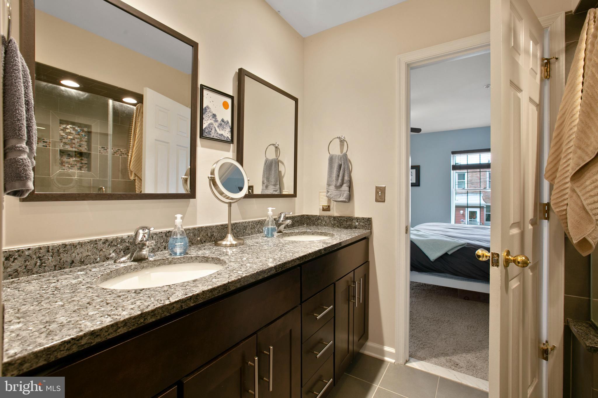 1230 Cooksie Street Baltimore, MD 21230 - Photo 23 of 41 a en suite bathroom with a granite countertop double vanity sink and a mirror