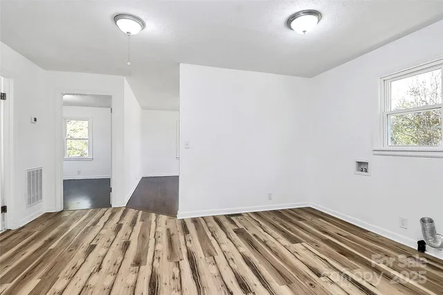 a view of a bedroom with wooden floor and bedroom