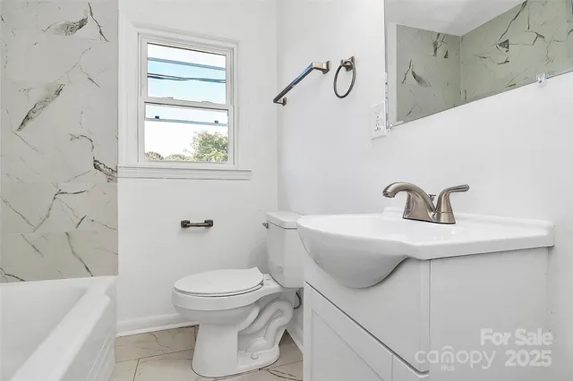 a bathroom with a sink a toilet and a bathtub