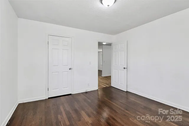 a view of a room with wooden floor