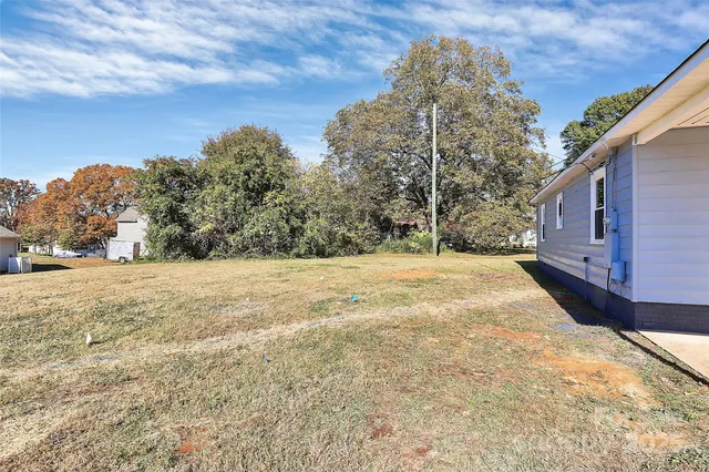 a view of large yard with large trees