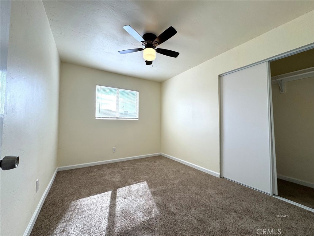 1500 West Alene Avenue Ridgecrest, CA 93555 - Photo 10 of 30 a view of a livingroom with a ceiling fan & windows