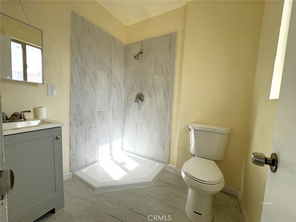 1500 West Alene Avenue Ridgecrest, CA 93555 - Photo 11 of 30 a white toilet sitting next to a bathroom sink