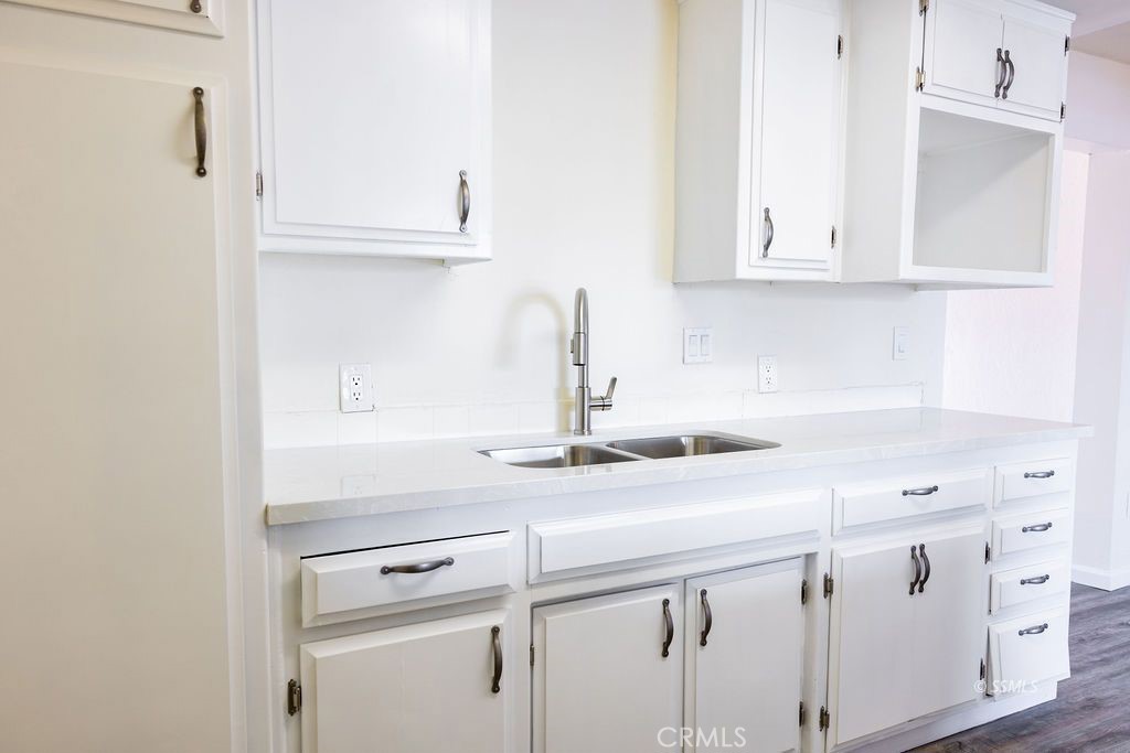 1500 West Alene Avenue Ridgecrest, CA 93555 - Photo 14 of 30 a kitchen with white cabinets and white appliances