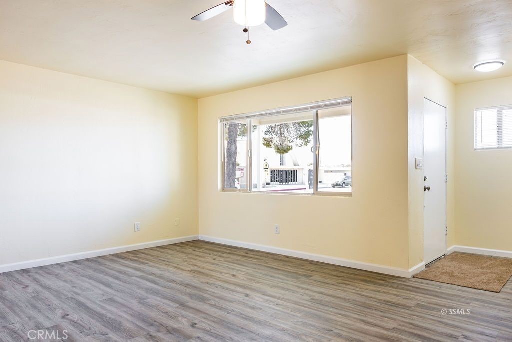 1500 West Alene Avenue Ridgecrest, CA 93555 - Photo 23 of 30 an empty room with wooden floor and windows