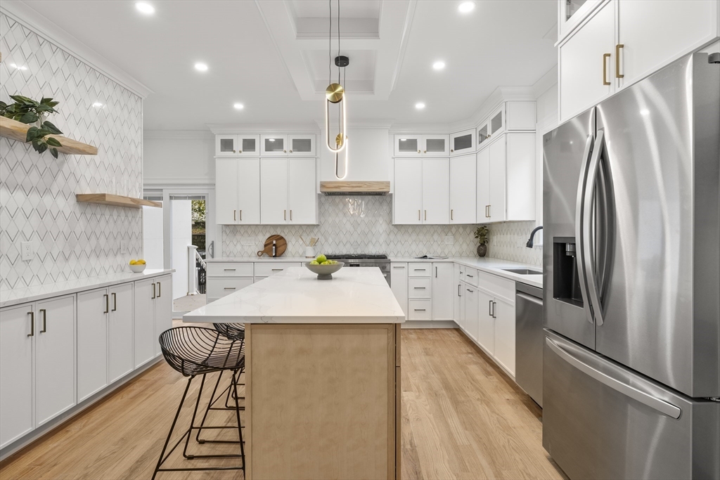 27 Coolidge Road, Unit 1 Boston, MA 02134 - Photo 11 of 41 a kitchen with stainless steel appliances refrigerator stove microwave and cabinets