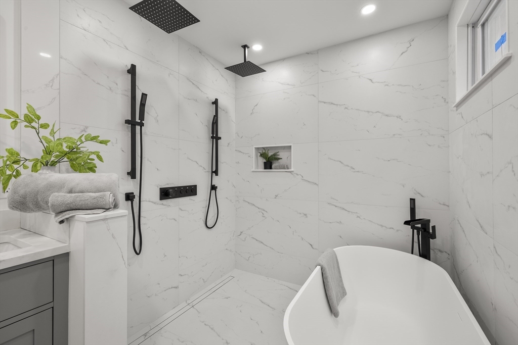 27 Coolidge Road, Unit 1 Boston, MA 02134 - Photo 19 of 41 a bathroom with a tub and shower