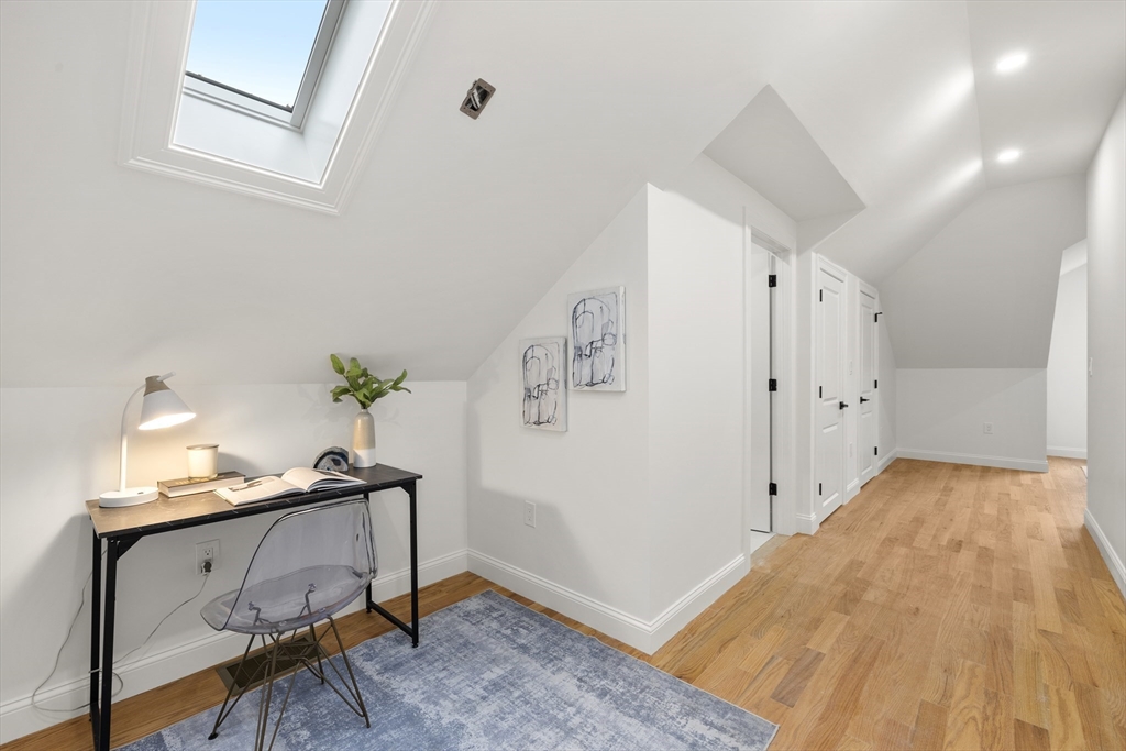 27 Coolidge Road, Unit 1 Boston, MA 02134 - Photo 20 of 41 a view of a bedroom with a bed and wooden floor