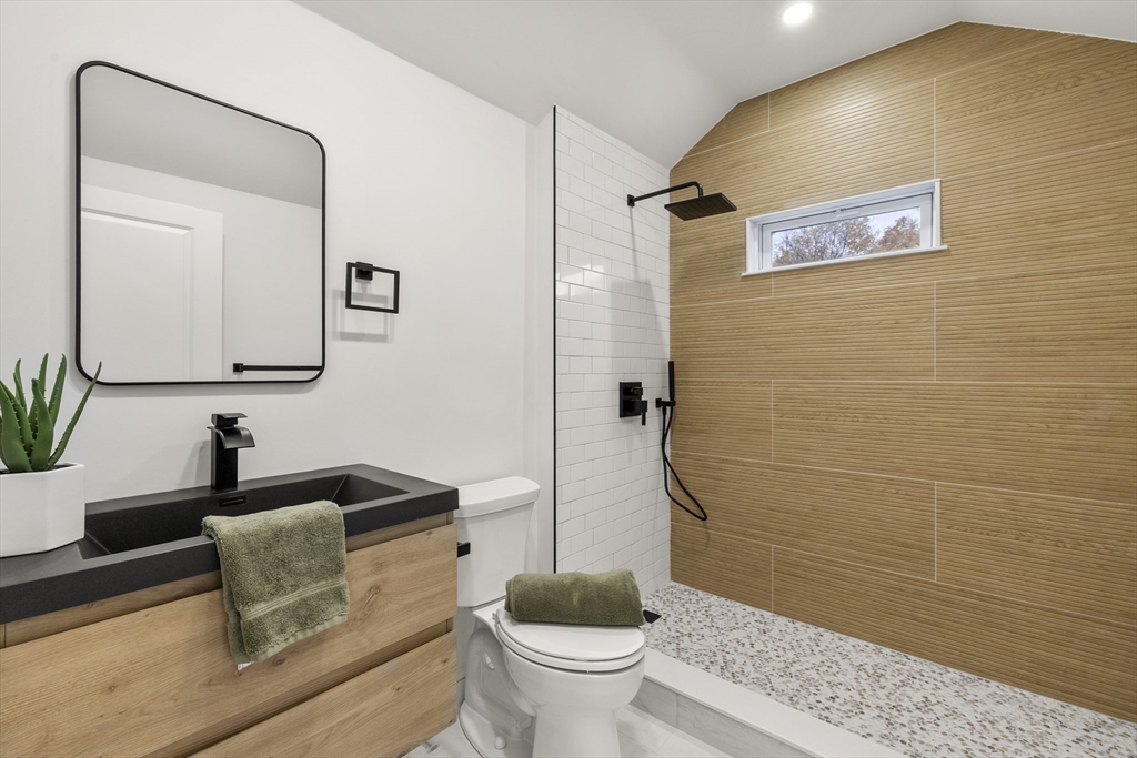 27 Coolidge Road, Unit 1 Boston, MA 02134 - Photo 21 of 41 a bathroom with a granite countertop sink and a mirror