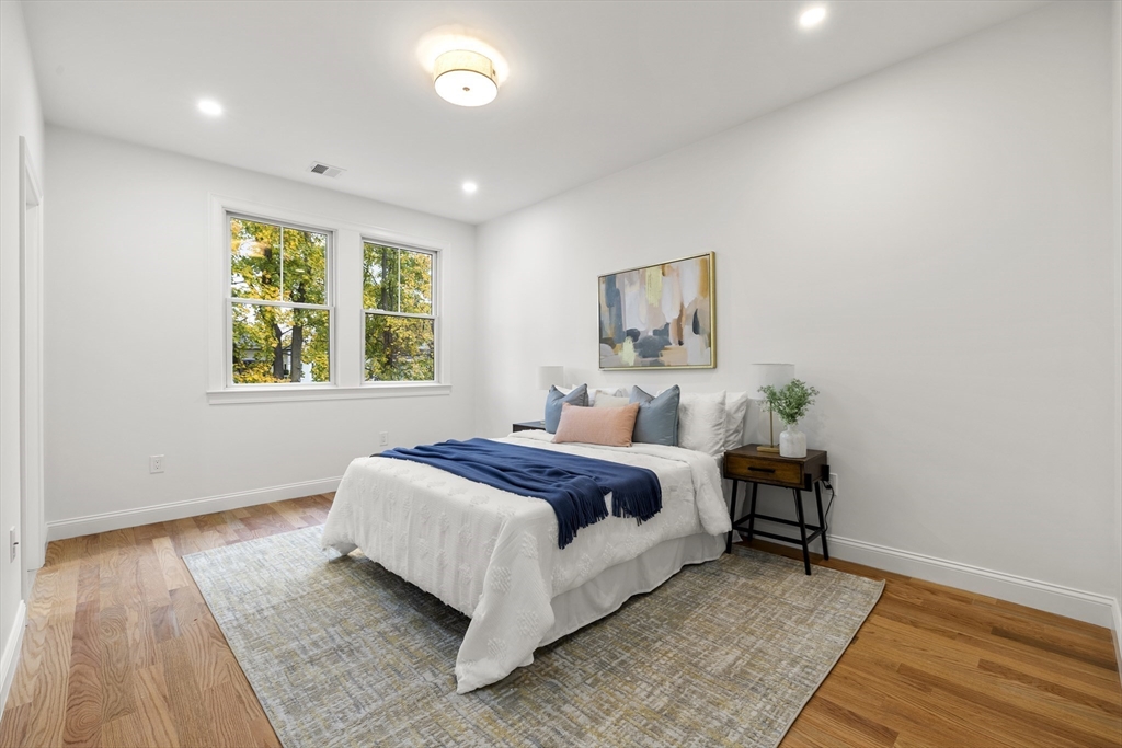 27 Coolidge Road, Unit 1 Boston, MA 02134 - Photo 25 of 41 a bedroom with a bed and a night stand