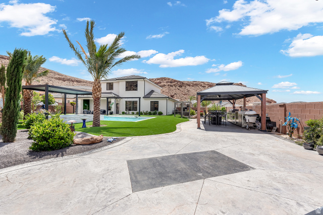 6105 Bunda Way St. George, UT 84790 - Photo 1 of 49 Expansive stamped concrete driveway with a dedicated covered parking structure