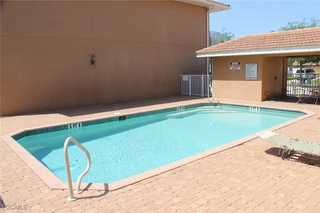 a view of a swimming pool with a lounge chair