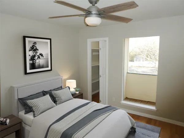 a bedroom with a large bed and a window