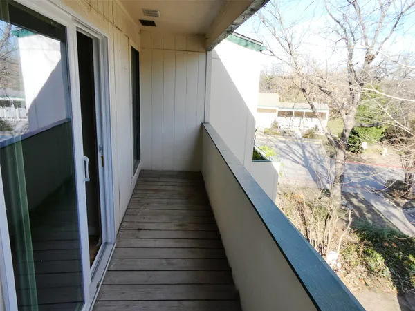 a view of balcony with wooden floor
