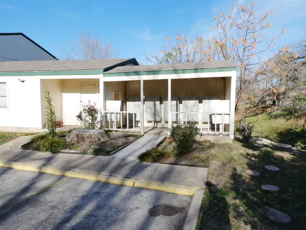 a view of a house with backyard porch and sitting area