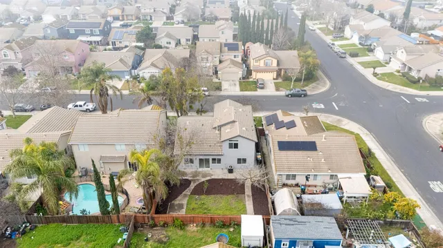 an aerial view of multi story residential apartment building with yard