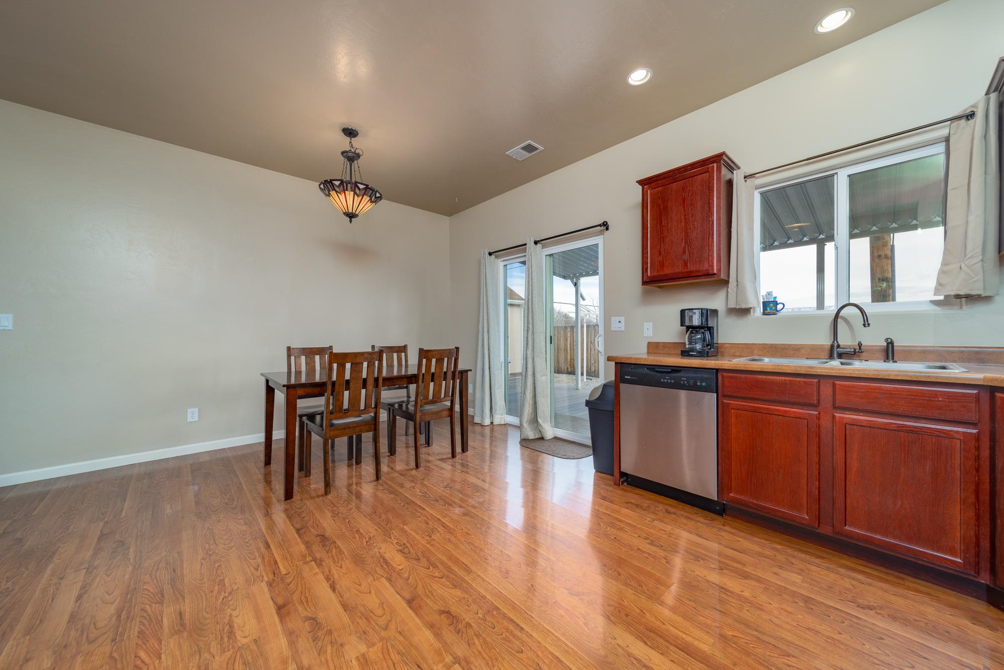 280 Gettysburg Street Grand Junction, CO 81503 - Photo 6 of 29 a kitchen with granite countertop a sink cabinets and wooden floor