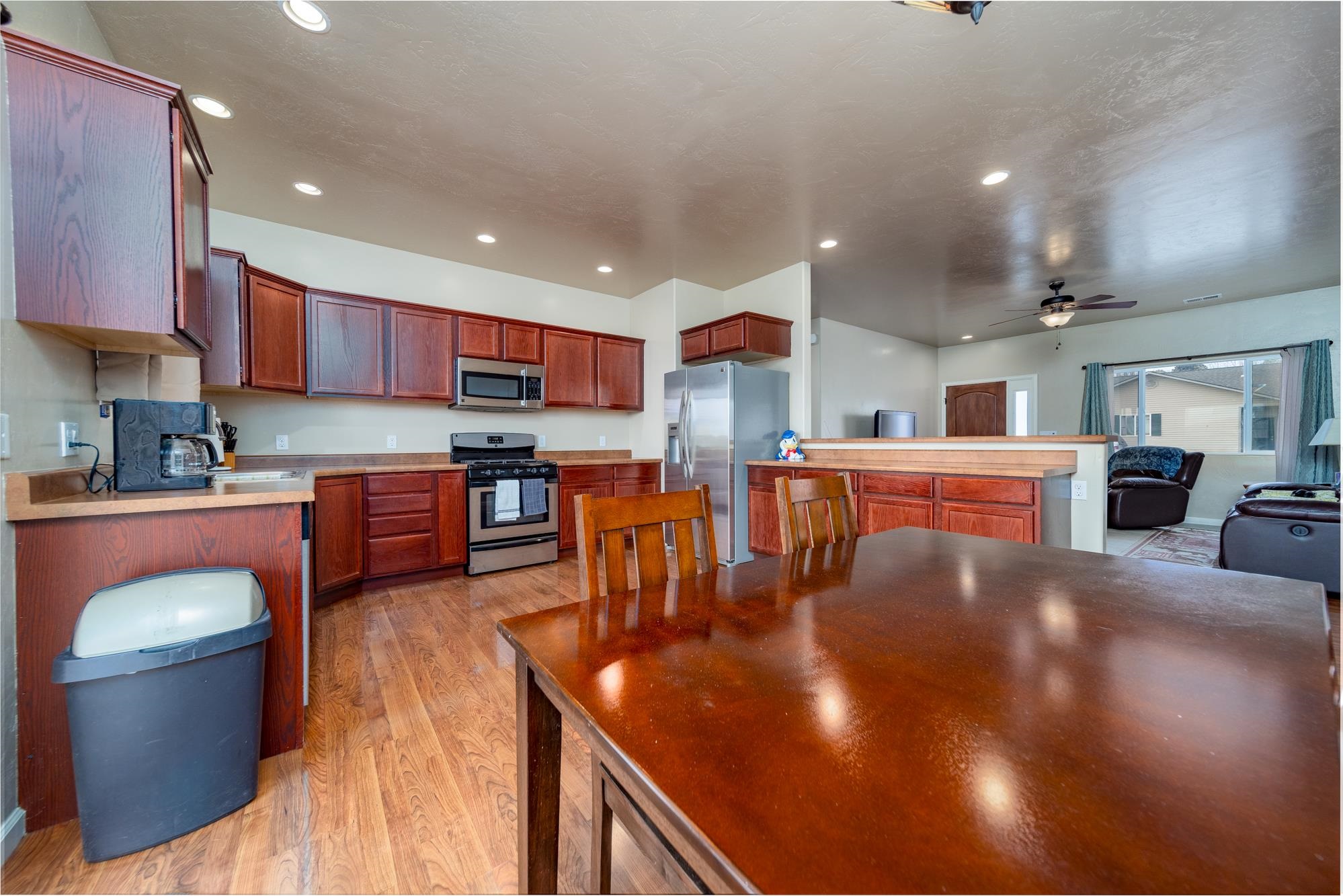 280 Gettysburg Street Grand Junction, CO 81503 - Photo 7 of 29 a kitchen with stainless steel appliances granite countertop a refrigerator a stove top oven a sink a dining table and chairs
