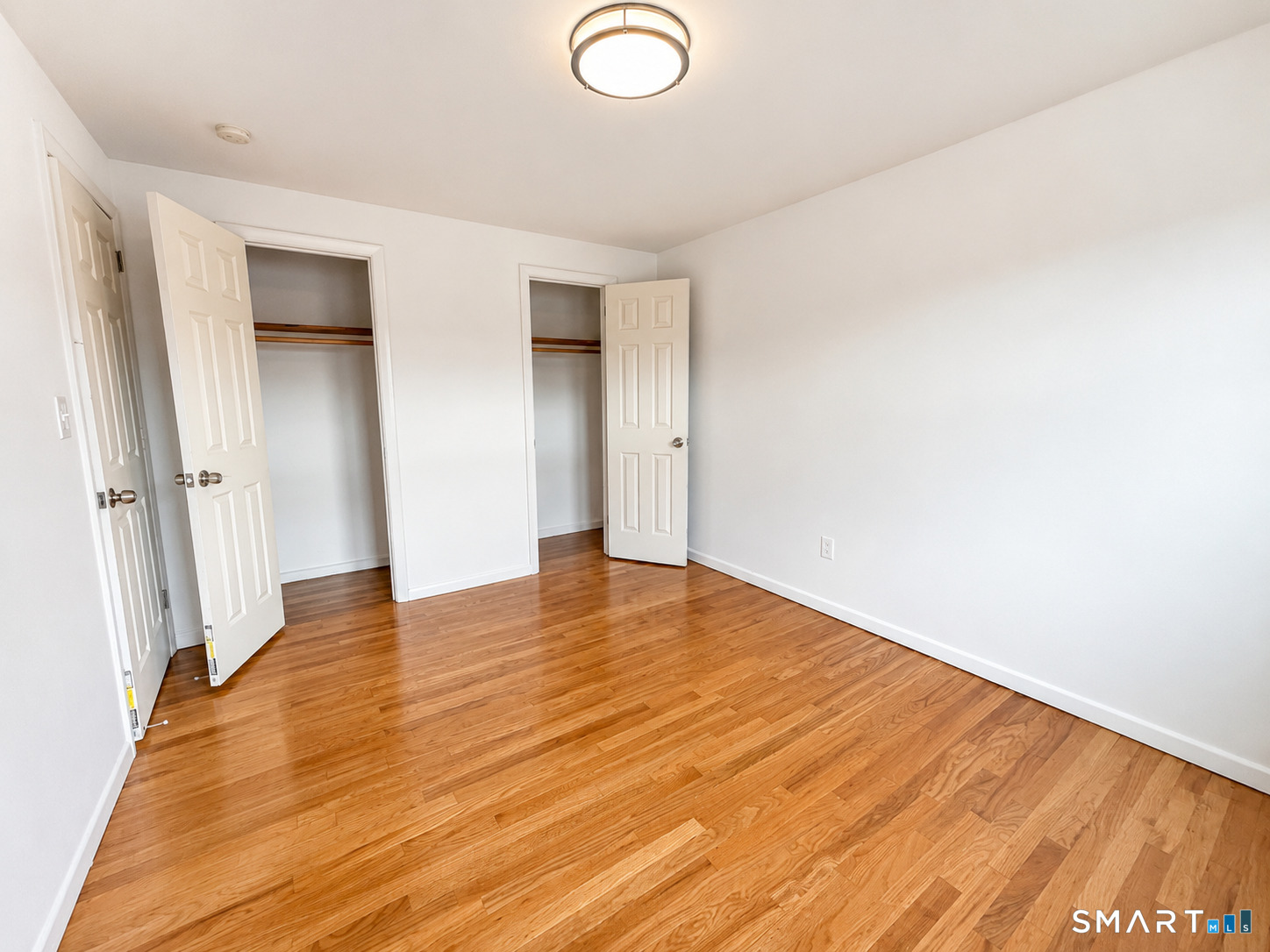 366 Park Road West Hartford, CT 06119 - Photo 5 of 8 an empty room with wooden floor and entrance