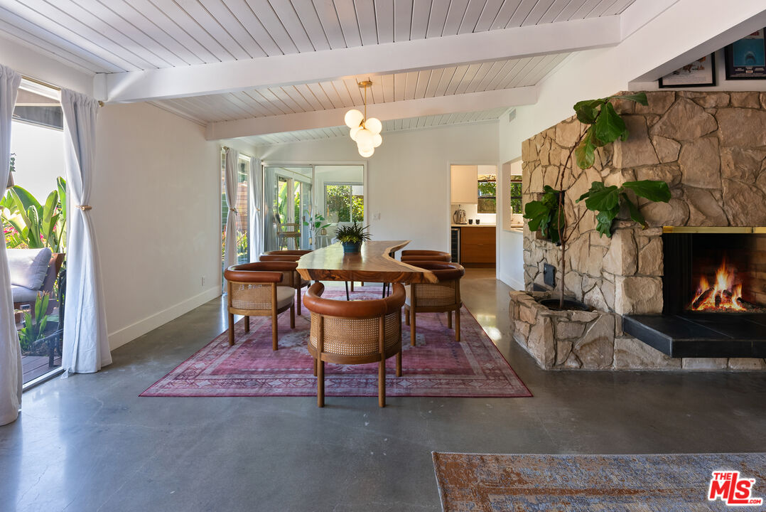 7211 Chelan Way Los Angeles, CA 90068 - Photo 11 of 38 a dining room with furniture a fireplace and wooden floor