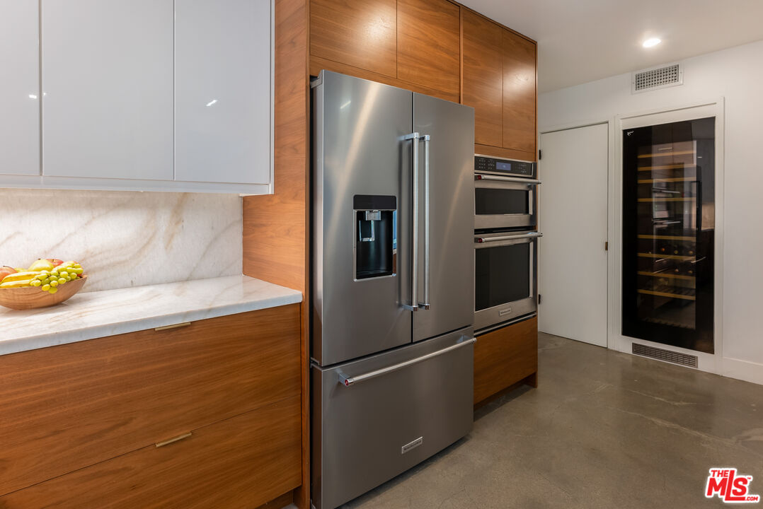 7211 Chelan Way Los Angeles, CA 90068 - Photo 17 of 38 a metallic refrigerator freezer sitting in a kitchen