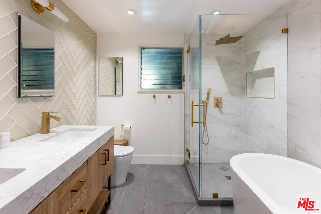 7211 Chelan Way Los Angeles, CA 90068 - Photo 22 of 38 a bathroom with a sink a toilet a mirror and shower
