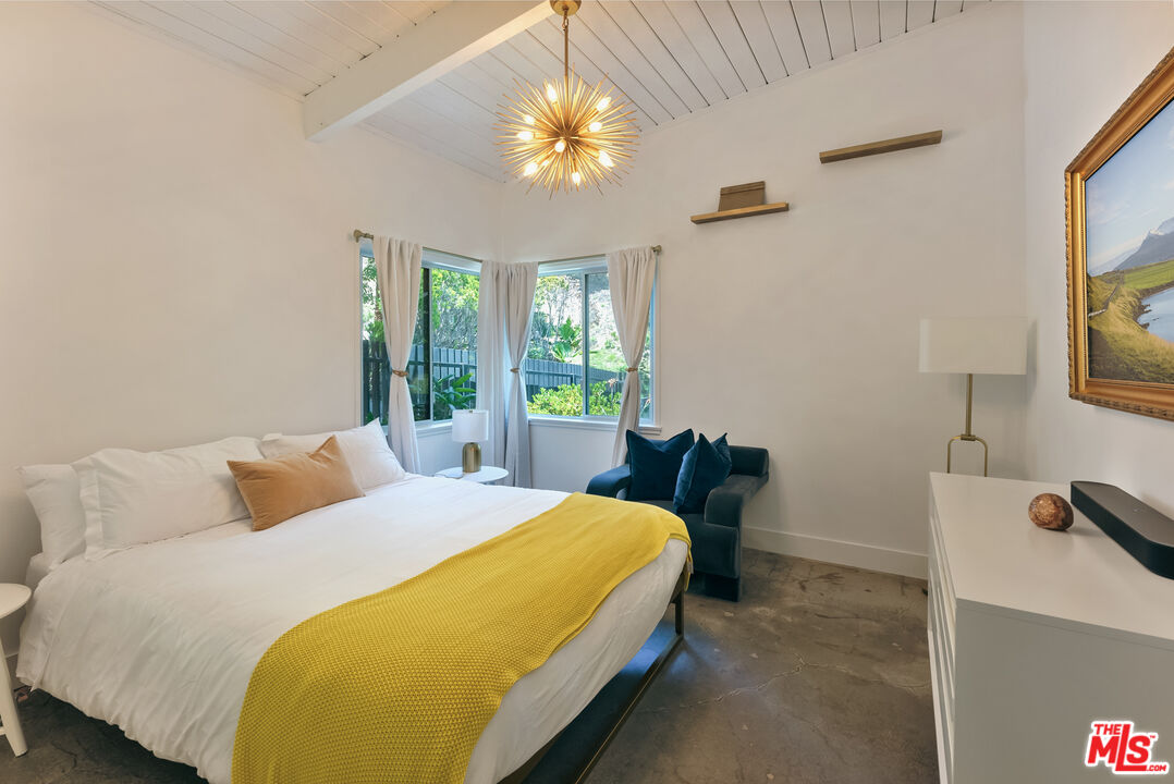 7211 Chelan Way Los Angeles, CA 90068 - Photo 24 of 38 a bedroom with a bed and a flat screen tv