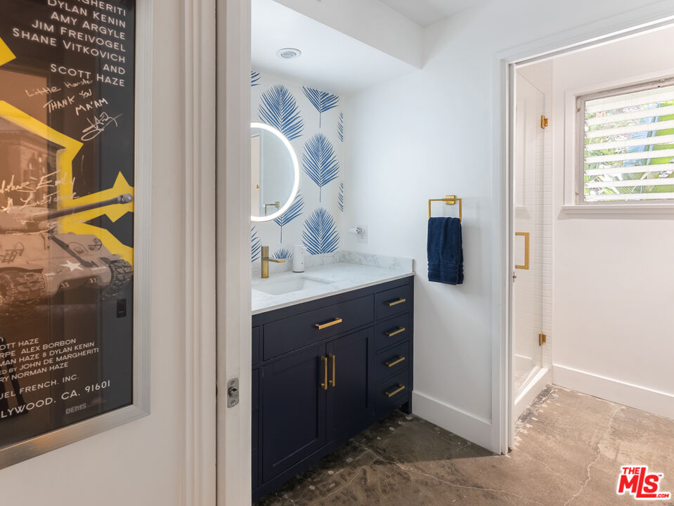 7211 Chelan Way Los Angeles, CA 90068 - Photo 25 of 38 a bathroom with a sink a mirror and a shower
