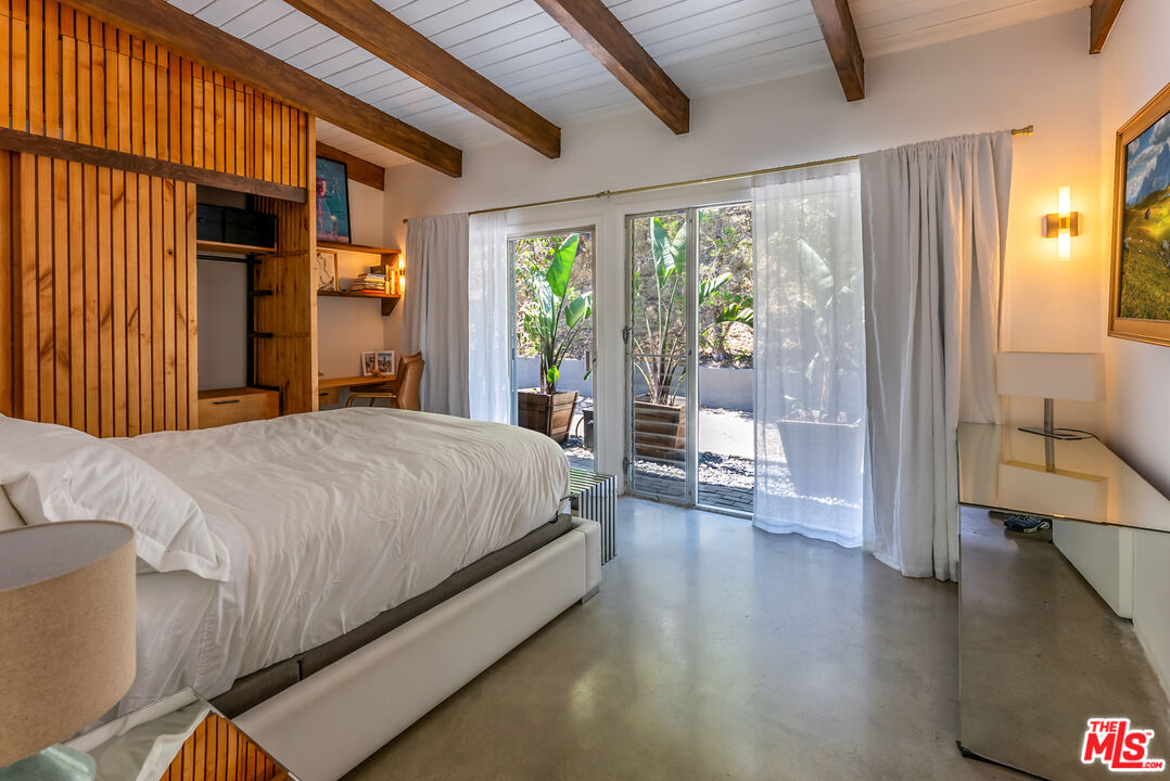 7211 Chelan Way Los Angeles, CA 90068 - Photo 26 of 38 a spacious bedroom with a large bed and a large window with outer view