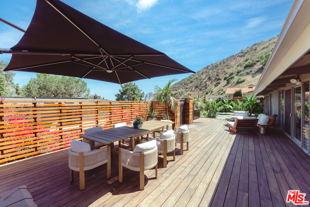 7211 Chelan Way Los Angeles, CA 90068 - Photo 33 of 38 a view of balcony with outdoor seating and wooden floor