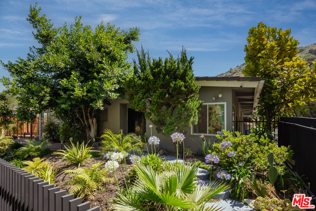 7211 Chelan Way Los Angeles, CA 90068 - Photo 4 of 38 front view of a house with a garden