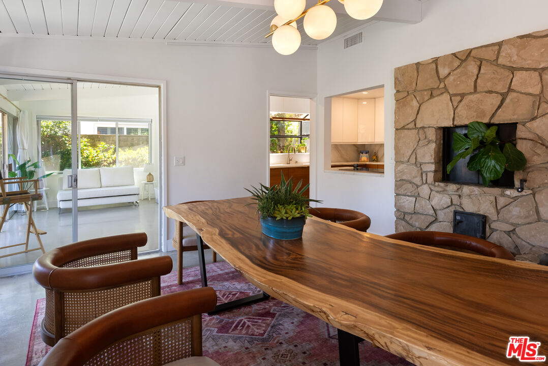 7211 Chelan Way Los Angeles, CA 90068 - Photo 9 of 38 a dining room with furniture and a potted plant