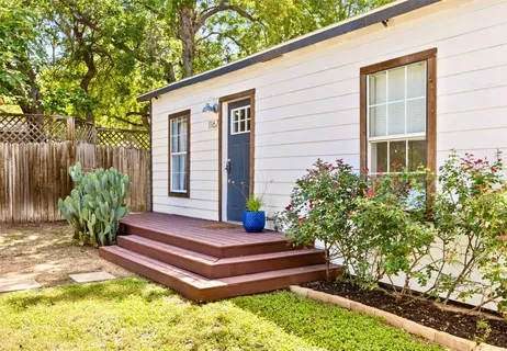 a front view of a house with a garden