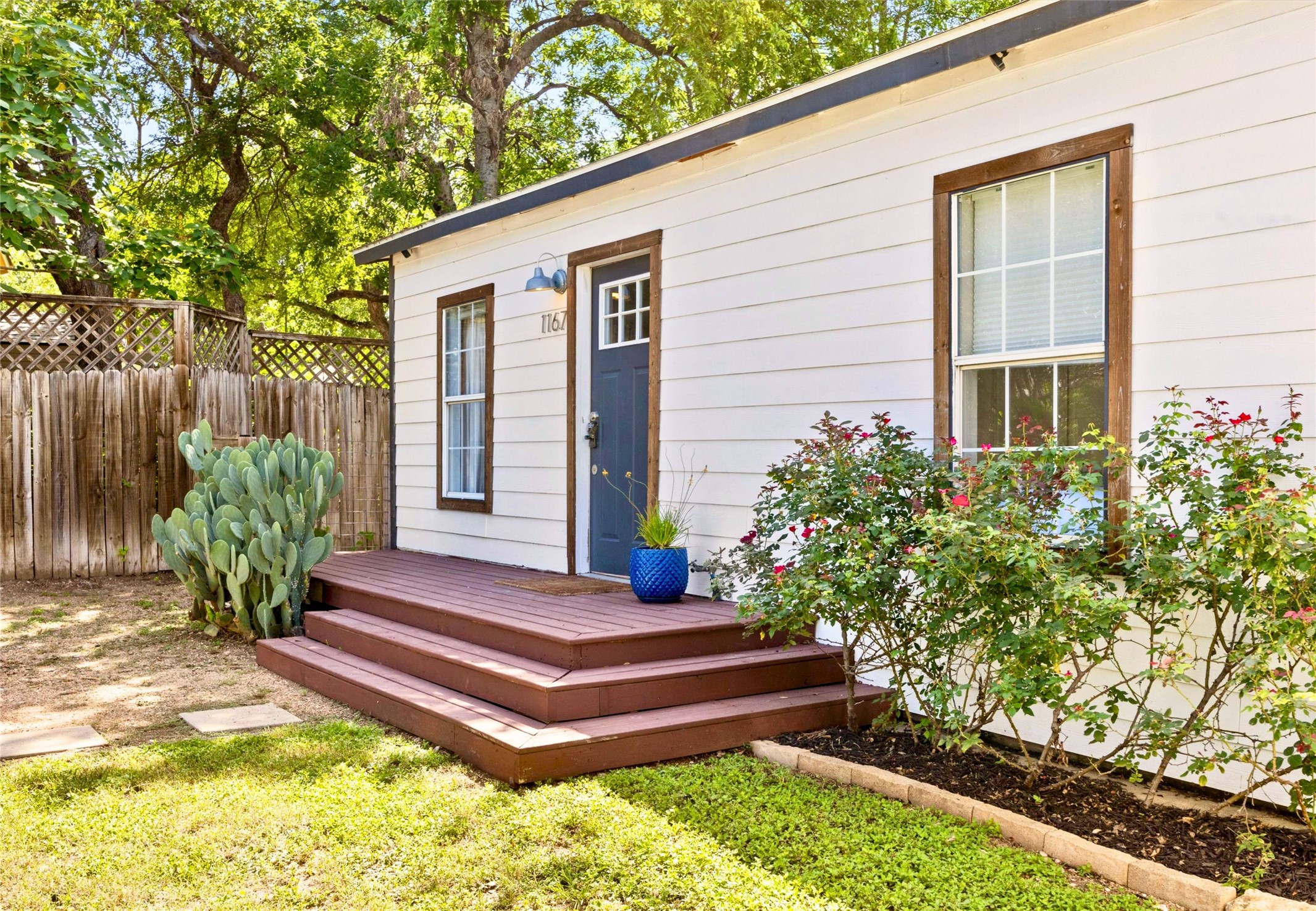 1167 Ridgeway Drive Austin, TX 78702 - Photo 3 of 29 a front view of a house with a garden