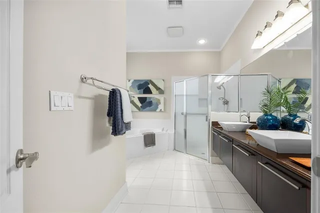 a large white room with a large mirror and sink