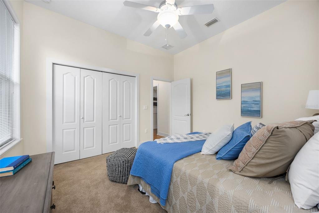 11064 Northwest 18th Road Gainesville, FL 32606 - Photo 21 of 30 a bedroom with a bed and a chandelier