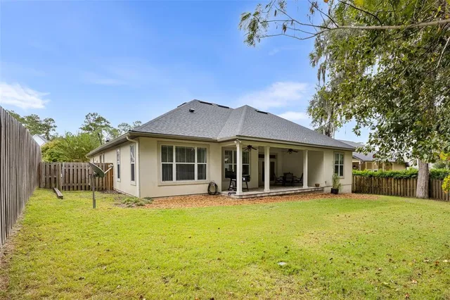 a view of a house with a yard patio and fire pit